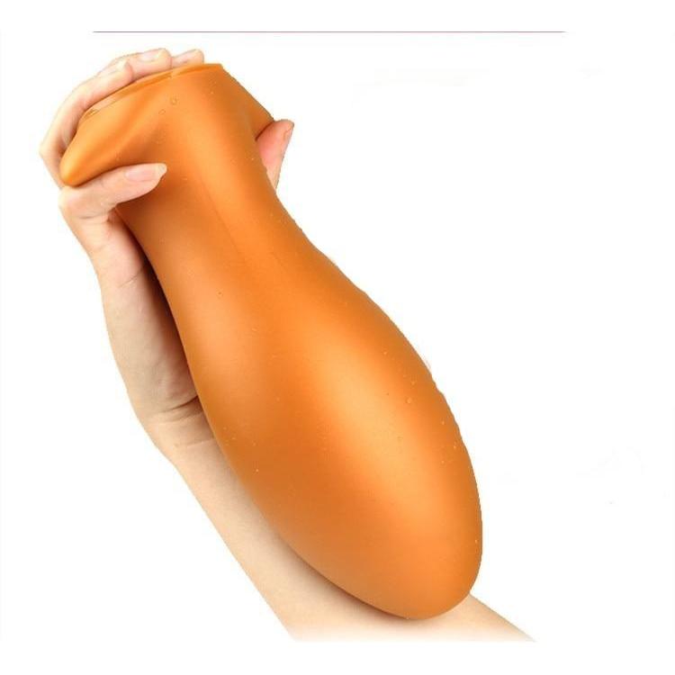 Plug anal XXL œuf flexible en silicone or prise en main